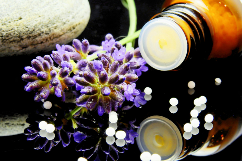 Servizio di Omeopatia e Omotossicologia Immagine di una boccetta accanto a un fiore che rappresenta l'omeopatia